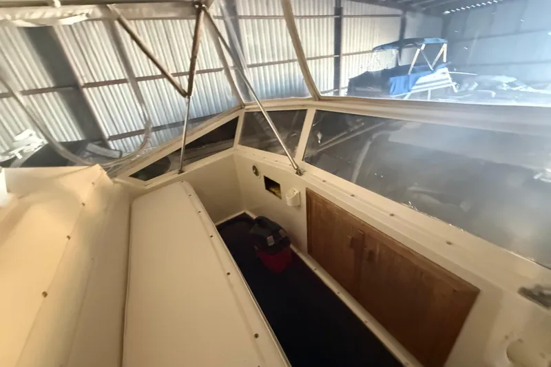 Slide: The Image of 1984 Viking 44 Motor Yacht interior with wooden cabinetry and large windows in a storage facility. - 31