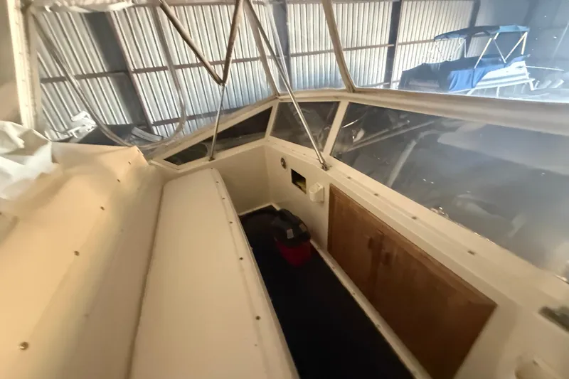 Slide: The Image of 1984 Viking 44 Motor Yacht interior with seating and storage, in a covered dock. - 32