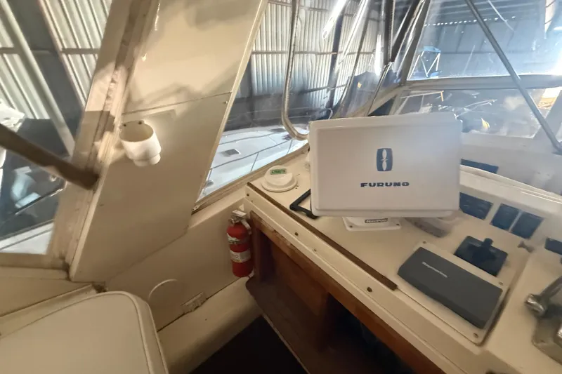 Slide: The Image of 1984 Viking 44 Motor Yacht helm with Furuno navigation system and fire extinguisher. - 39