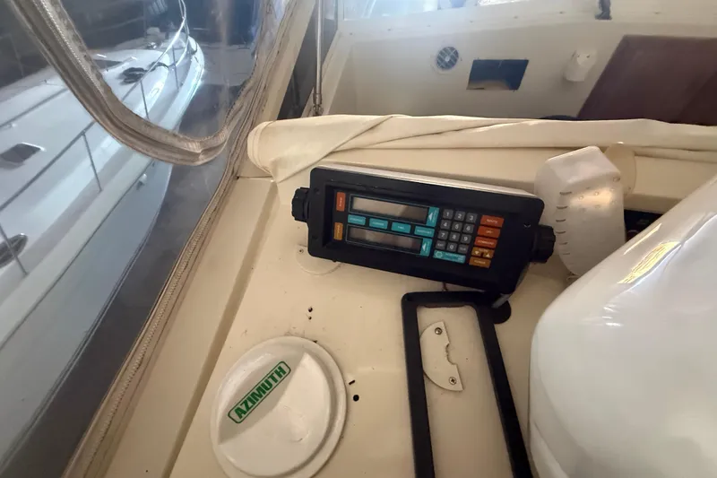 Slide: The Image of Control panel on 1984 Viking 44 Motor Yacht, featuring navigation equipment and Azimuth compass. - 40