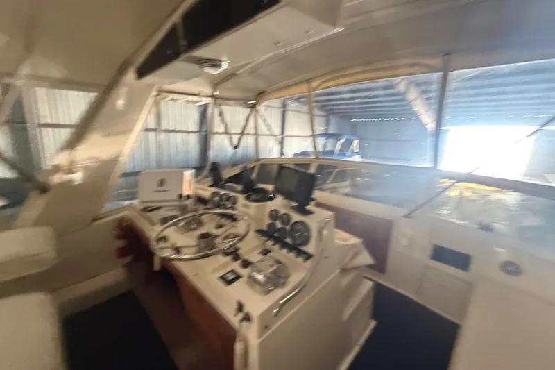 Slide: The Image of 1984 Viking 44 Motor Yacht helm with steering wheel and navigation instruments. - 45