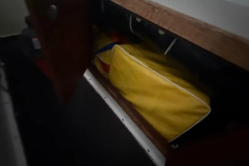 Slide: The Image of Open storage compartment on 1984 Viking 44 Motor Yacht with yellow bag inside. - 46