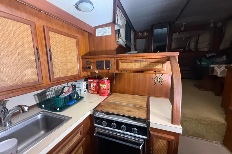 Slide: The Image of 1984 Viking 44 Motor Yacht kitchen with wood cabinetry and compact appliances. - 54