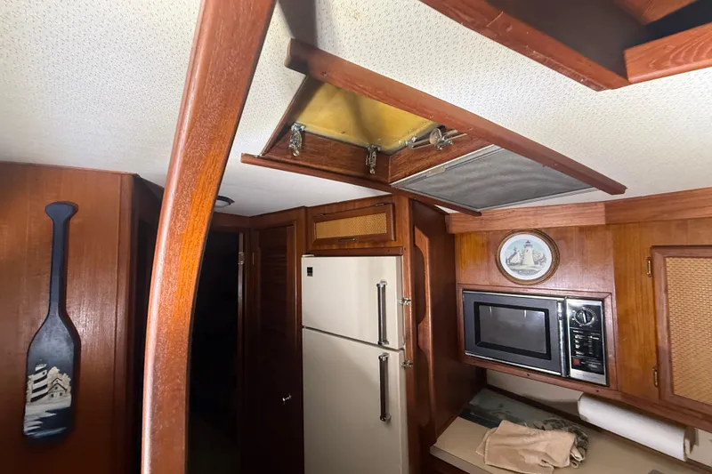Slide: The Image of Interior of 1984 Viking 44 Motor Yacht with kitchen appliances and wooden decor. - 58