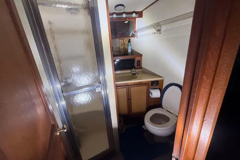 Slide: The Image of Bathroom interior of 1984 Viking 44 Motor Yacht with shower, sink, and toilet. - 60