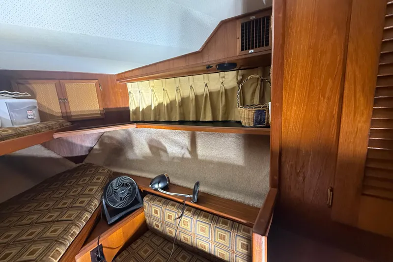 Slide: The Image of 1984 Viking 44 Motor Yacht interior with wood paneling and patterned seating. - 64