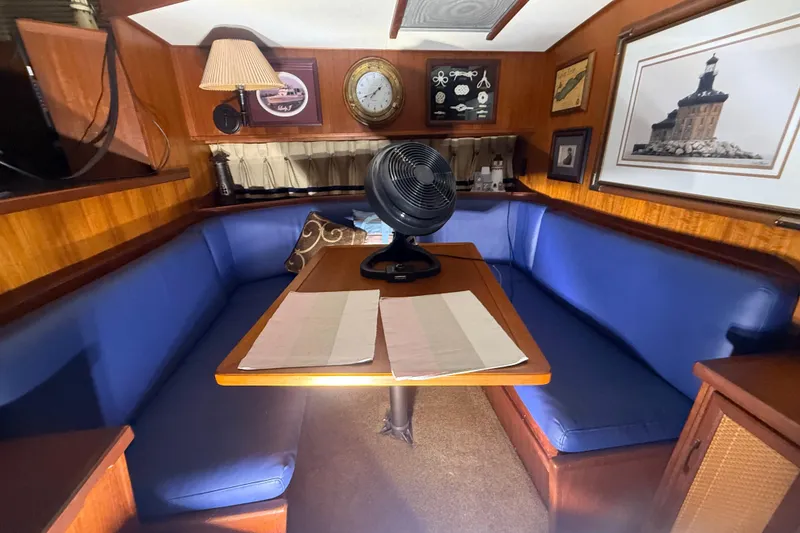 Slide: The Image of Cozy dining area in 1984 Viking 44 Motor Yacht with blue seating and nautical decor. - 68