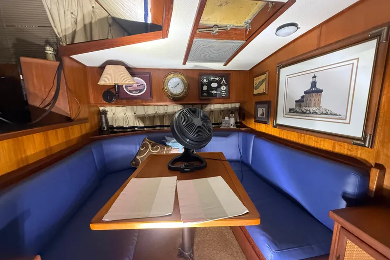 Slide: The Image of Cozy interior of 1984 Viking 44 Motor Yacht with blue seating and nautical decor. - 69