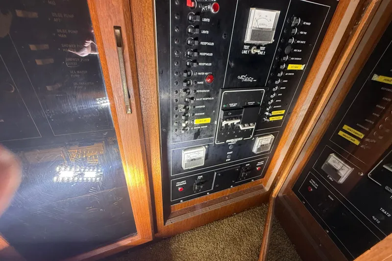 Slide: The Image of Electrical panel of a 1984 Viking 44 Motor Yacht with switches and meters. - 71