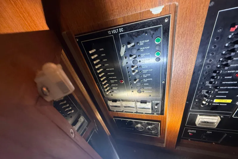 Slide: The Image of Control panel of a 1984 Viking 44 Motor Yacht, featuring 12-volt DC switches. - 73