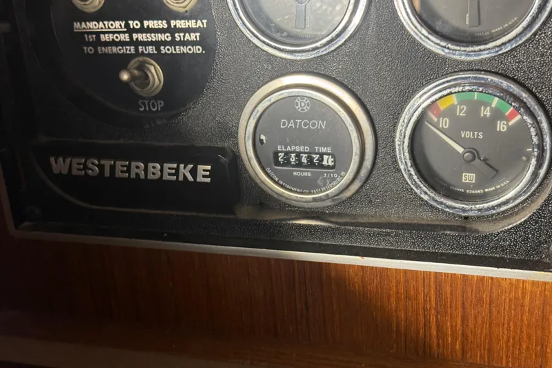 Slide: The Image of Control panel of 1984 Viking 44 Motor Yacht with gauges and Westerbeke label. - 76