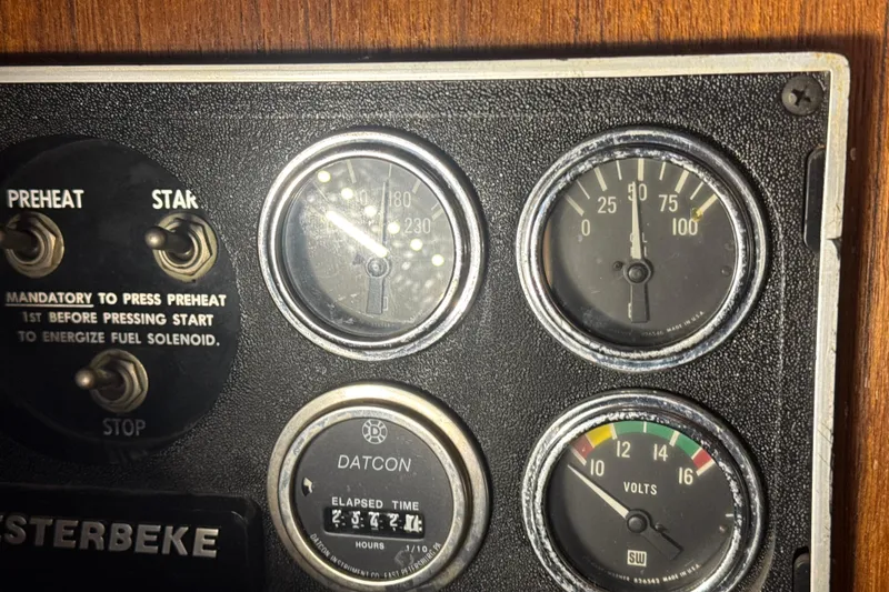 Slide: The Image of Control panel of a 1984 Viking 44 Motor Yacht with gauges and switches. - 78