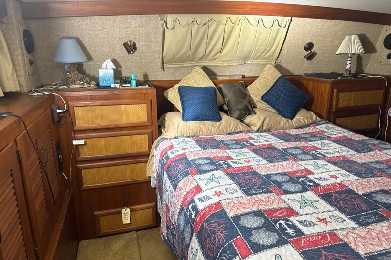 Slide: The Image of Cozy bedroom interior of 1984 Viking 44 Motor Yacht with nautical-themed bedding. - 80