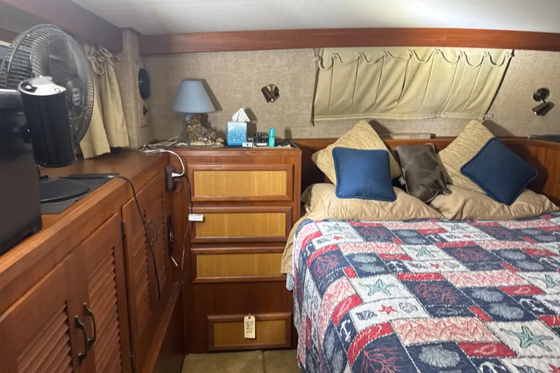 Slide: The Image of Cozy bedroom interior of 1984 Viking 44 Motor Yacht with nautical-themed bedding. - 81