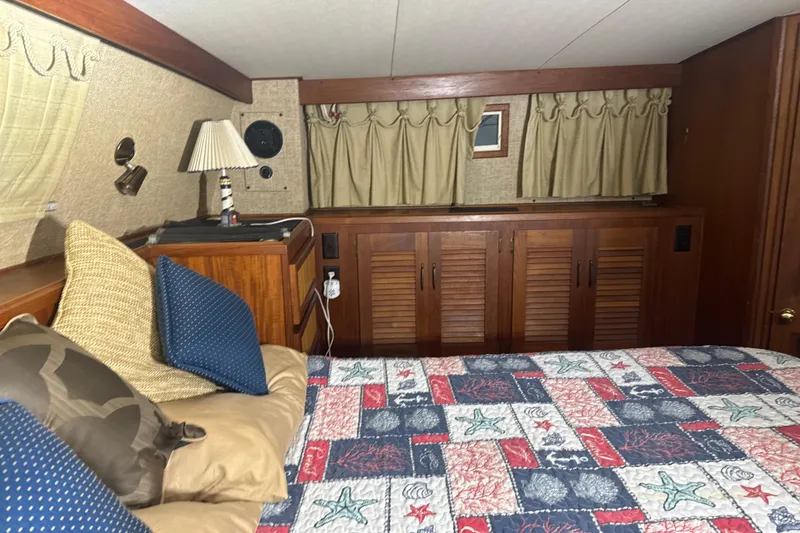 Slide: The Image of Cozy bedroom interior of 1984 Viking 44 Motor Yacht with nautical-themed bedding. - 83