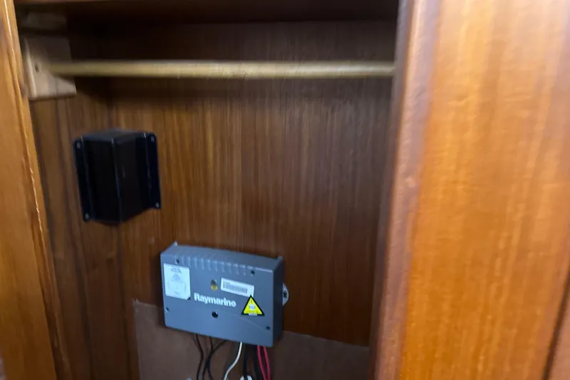 Slide: The Image of 1984 Viking 44 Motor Yacht interior with Raymarine equipment in wooden cabinet. - 84