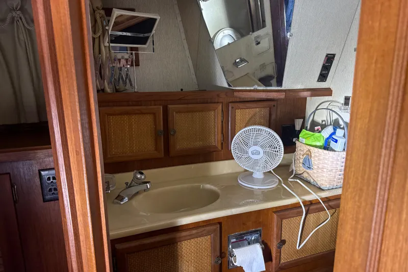 Slide: The Image of 1984 Viking 44 Motor Yacht bathroom with sink, fan, and storage basket. - 85