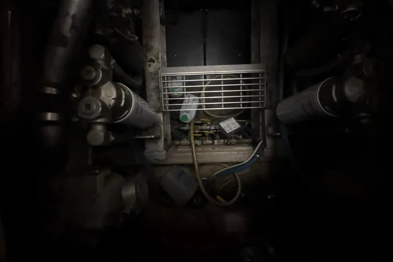 Slide: The Image of Engine room of a 1984 Viking 44 Motor Yacht with visible components and wiring. - 89