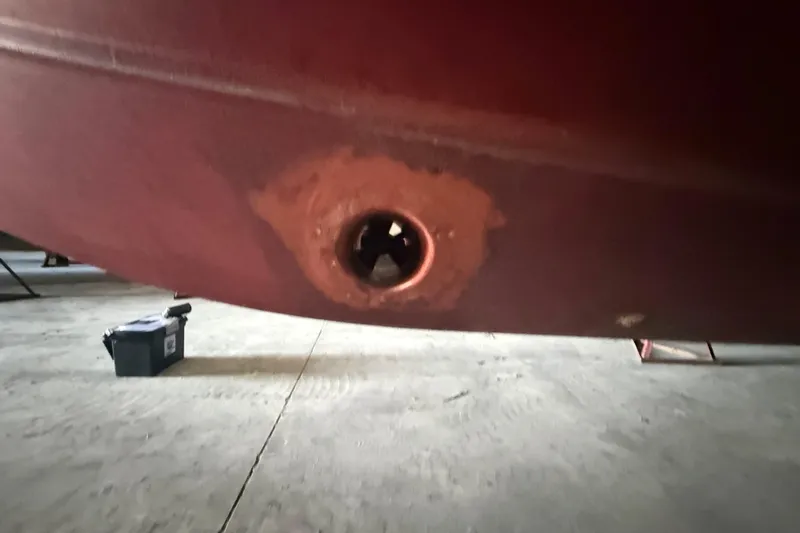 Slide: The Image of 1984 Viking 44 Motor Yacht hull detail in dry dock, showing a through-hull fitting. - 9