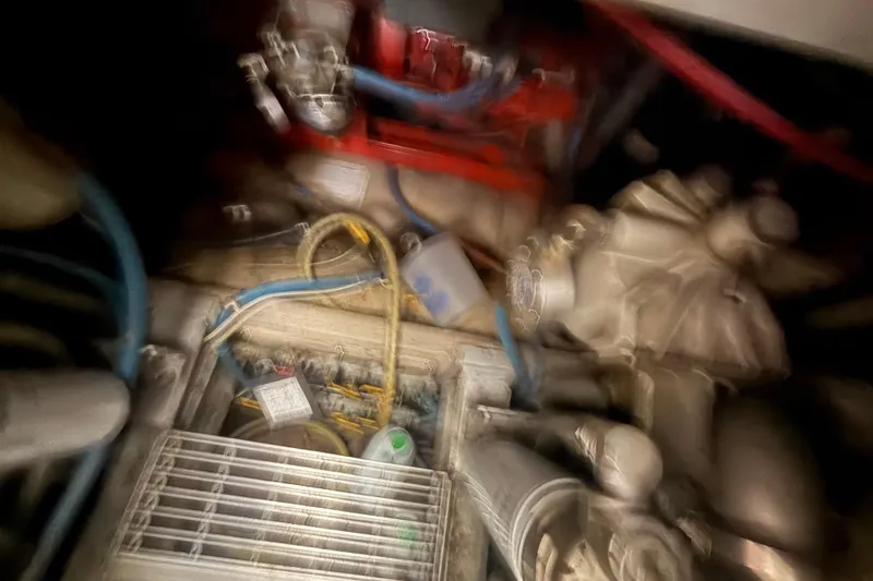 Slide: The Image of Blurry engine room of 1984 Viking 44 Motor Yacht with visible components and wiring. - 90