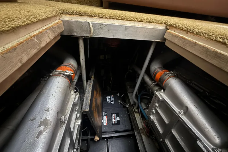Slide: The Image of Engine room of 1984 Viking 44 Motor Yacht with visible components and battery. - 91