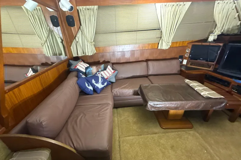 Slide: The Image of Interior of 1984 Viking 44 Motor Yacht with brown leather seating and nautical decor. - 92
