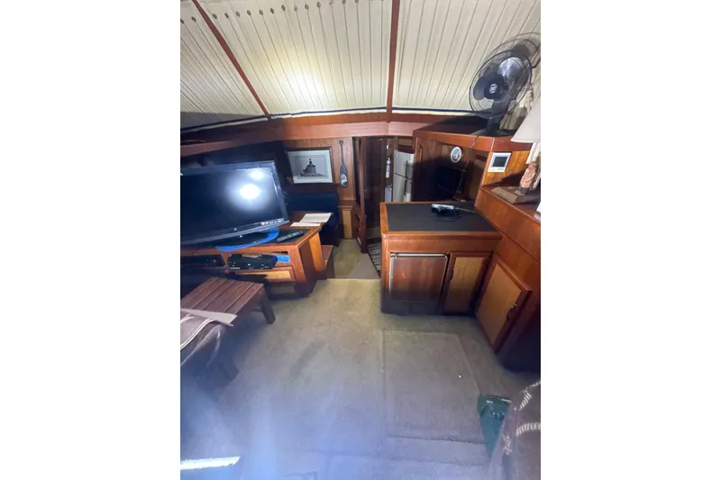 Slide: The Image of Interior of 1984 Viking 44 Motor Yacht with TV, fan, and wooden cabinetry. - 97