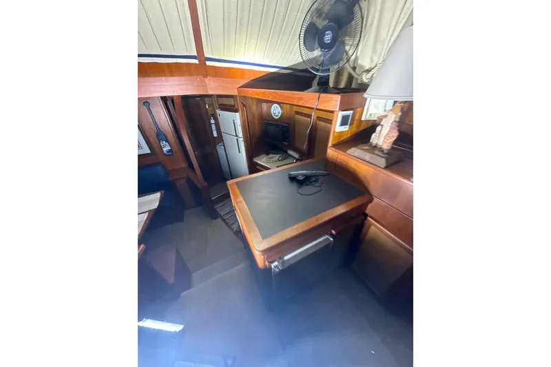 Slide: The Image of 1984 Viking 44 Motor Yacht interior with wood cabinetry, fridge, and fan. - 98