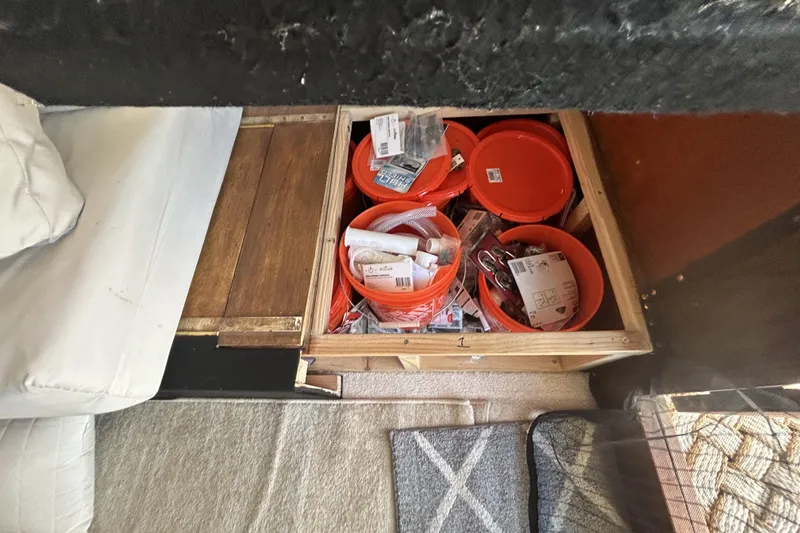 Slide: The Image of Storage compartment with orange buckets and supplies on Ocean Alexander 50 Pilothouse, 1981 model. - 12