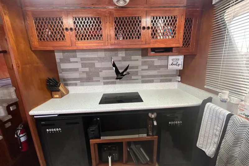 Slide: The Image of 1981 Ocean Alexander 50 Pilothouse kitchen with modern appliances and wooden cabinetry. - 15