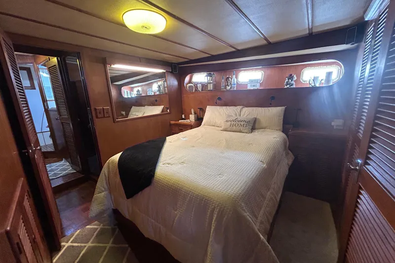 Slide: The Image of Cozy bedroom interior of 1981 Ocean Alexander 50 Pilothouse yacht with wood paneling and decor. - 18