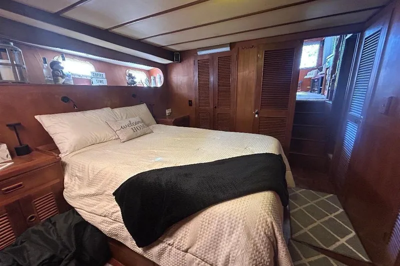 Slide: The Image of Cozy bedroom in 1981 Ocean Alexander 50 Pilothouse yacht with wood paneling and comfortable bedding. - 19