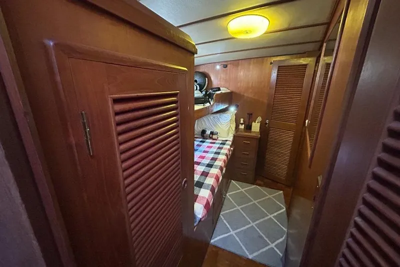 Slide: The Image of Cozy cabin interior of 1981 Ocean Alexander 50 Pilothouse with wooden furnishings and plaid bedding. - 22