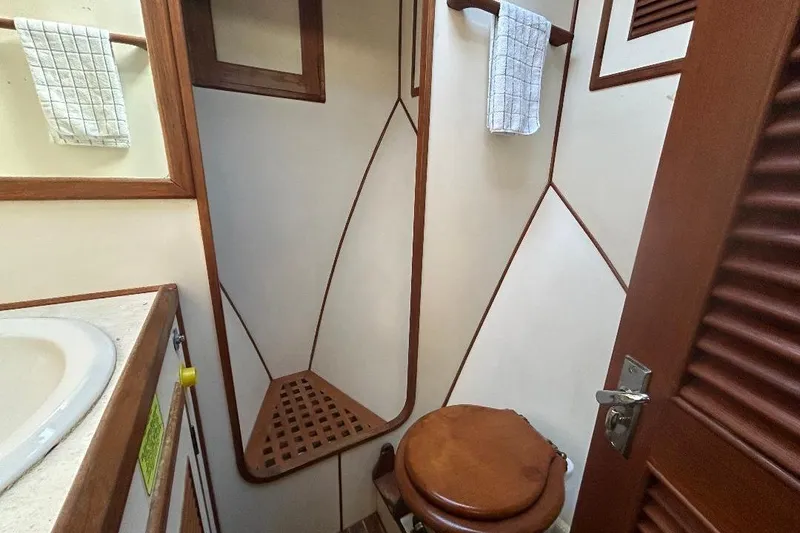 Slide: The Image of 1981 Ocean Alexander 50 Pilothouse bathroom with wooden accents and compact design. - 24