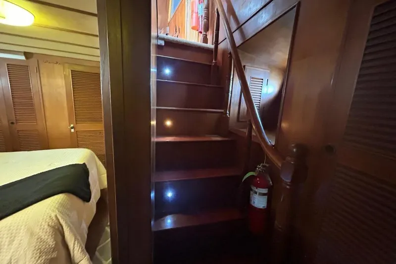 Slide: The Image of Interior of 1981 Ocean Alexander 50 Pilothouse with wooden stairs and cozy cabin. - 25