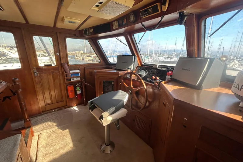 Slide: The Image of Interior of 1981 Ocean Alexander 50 Pilothouse with wooden helm and navigation equipment. - 27