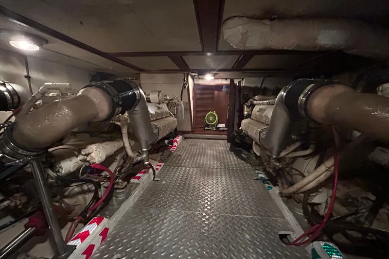 Slide: The Image of Engine room of 1981 Ocean Alexander 50 Pilothouse yacht with visible machinery and piping. - 33