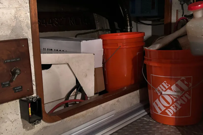 Slide: The Image of Interior of 1981 Ocean Alexander 50 Pilothouse with Home Depot buckets and storage items. - 40