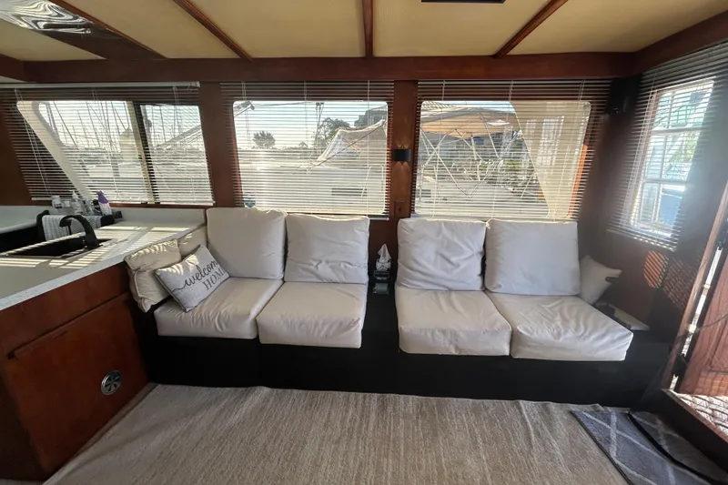 Slide: The Image of Interior of 1981 Ocean Alexander 50 Pilothouse with white sofa and large windows. - 5