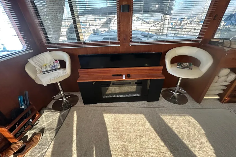 Slide: The Image of Interior of 1981 Ocean Alexander 50 Pilothouse with chairs, TV, and books. - 6