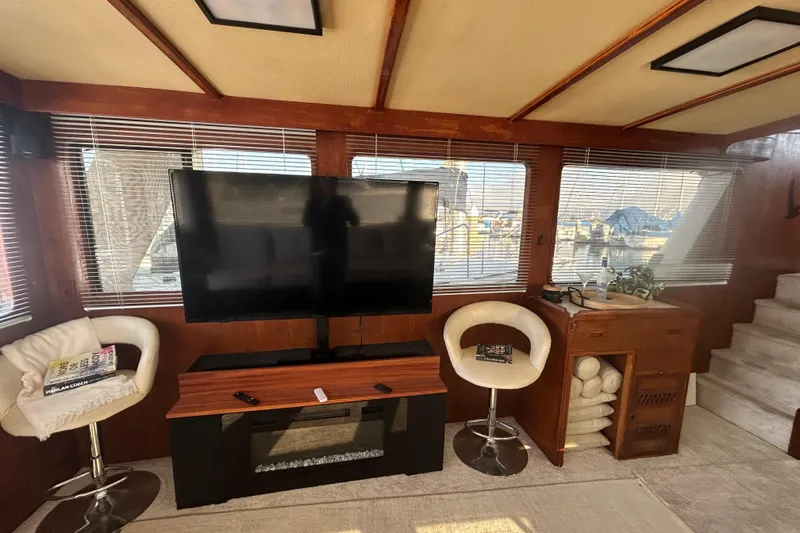 Slide: The Image of Interior of 1981 Ocean Alexander 50 Pilothouse with TV, chairs, and windows. - 7