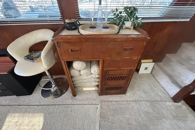 Slide: The Image of 1981 Ocean Alexander 50 Pilothouse interior with wooden cabinet, chair, and decor elements. - 9