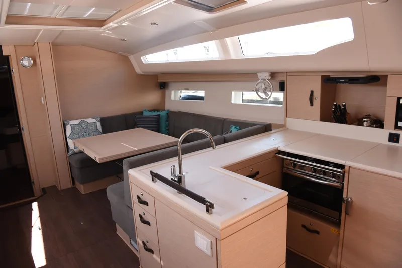 Slide: The Image of Luxurious interior of 2019 Jeanneau 51 yacht with modern kitchen and cozy seating area. - 11
