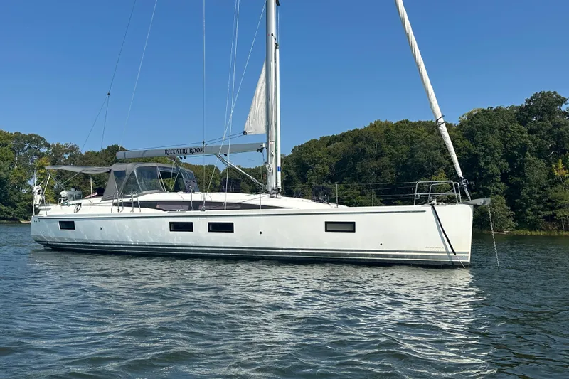 Slide: The Image of 2019 Jeanneau 51 sailboat on calm water. - 14