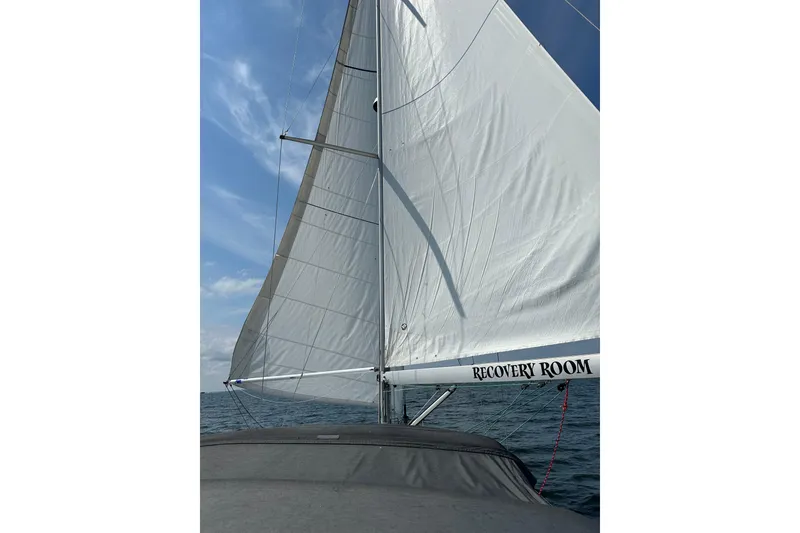 Slide: The Image of Sailing on a 2019 Jeanneau 51 yacht with white sails against a blue sky. - 16