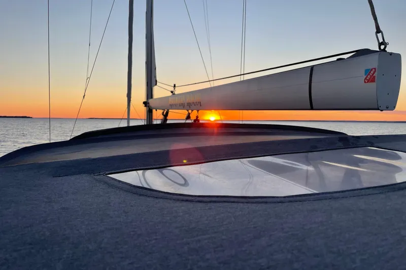 Slide: The Image of 2019 Jeanneau 51 sailboat at sunset on the ocean. - 20