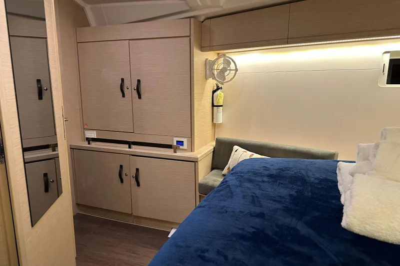 Slide: The Image of Luxurious interior of 2019 Jeanneau 51 yacht with cozy bed and modern cabinetry. - 29