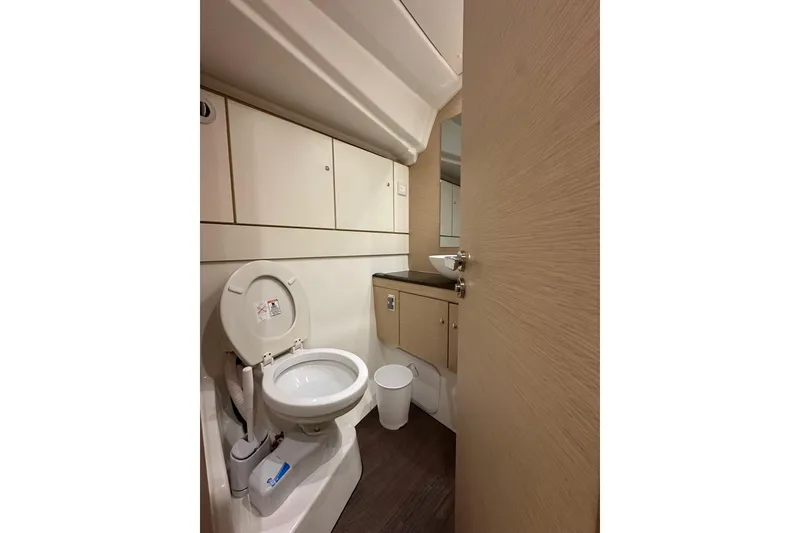Slide: The Image of Bathroom interior of 2019 Jeanneau 51 yacht with modern fixtures and wood accents. - 31