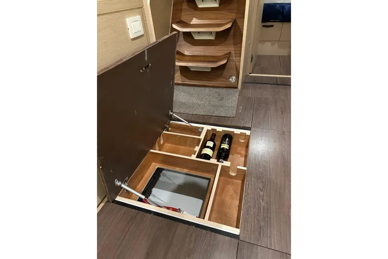 Slide: The Image of Hidden wine storage in 2019 Jeanneau 51 yacht interior, featuring wooden compartments. - 36