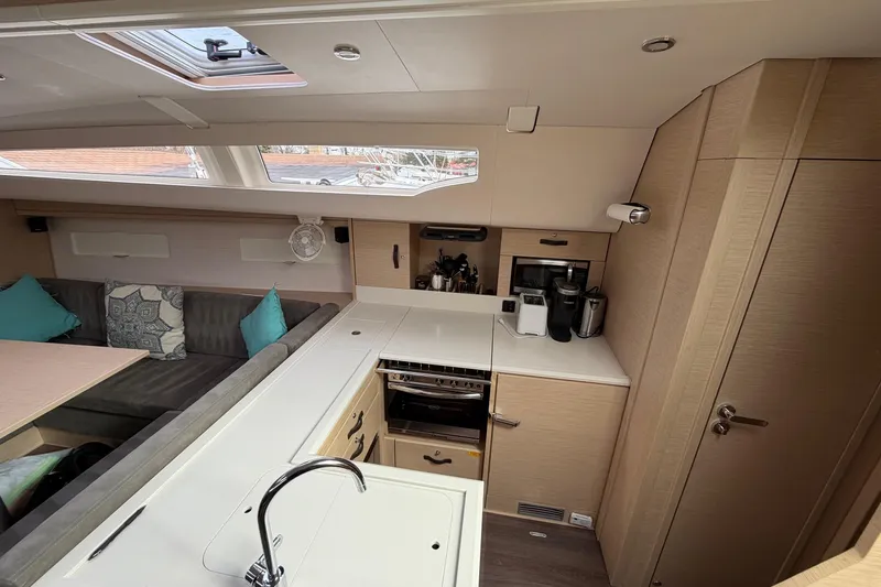 Slide: The Image of Modern interior of 2019 Jeanneau 51 yacht with kitchen and seating area. - 40
